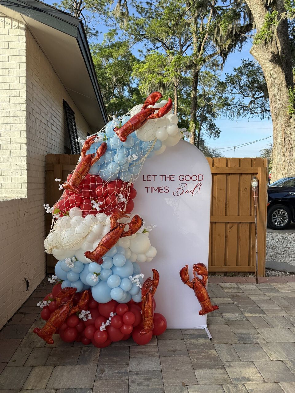 Red and white balloon display outside a building entrance